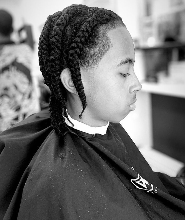 Braided style with a shaped hairline and clean temple work at Macveli Cuts, South London