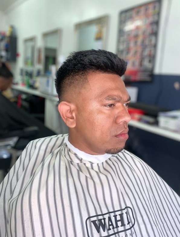 A finished mid taper fade with a textured quiff, cut at Macveli Cuts